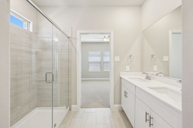 505 Willet Dr, Mckinney, TX 75069 - bathroom featuring double vanity, a stall shower, and ceiling fan