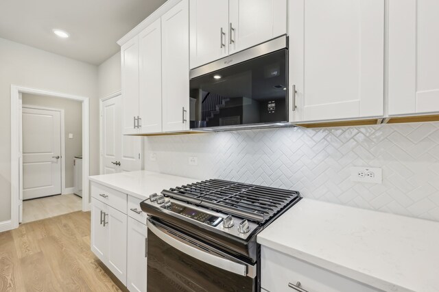 505 Willet Dr, Mckinney, TX 75069 - kitchen featuring appliances with stainless steel finishes, light wood finished floors, decorative backsplash, white cabinetry, and light stone counters