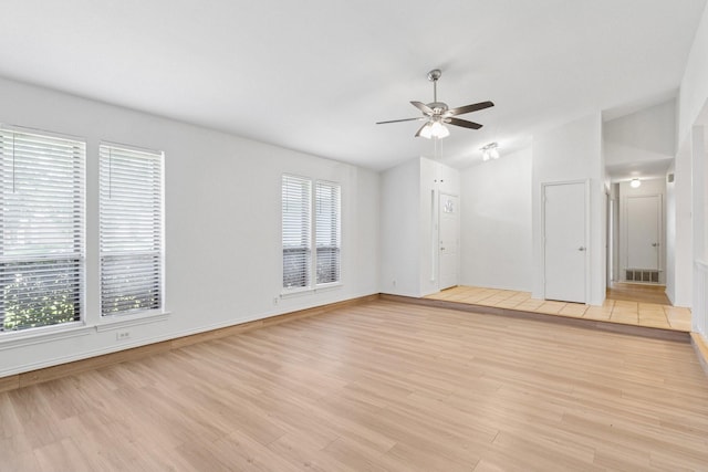 1109 Paluxy Ct, Flower Mound, TX 75028 - unfurnished living room with lofted ceiling, ceiling fan, and light wood-type flooring