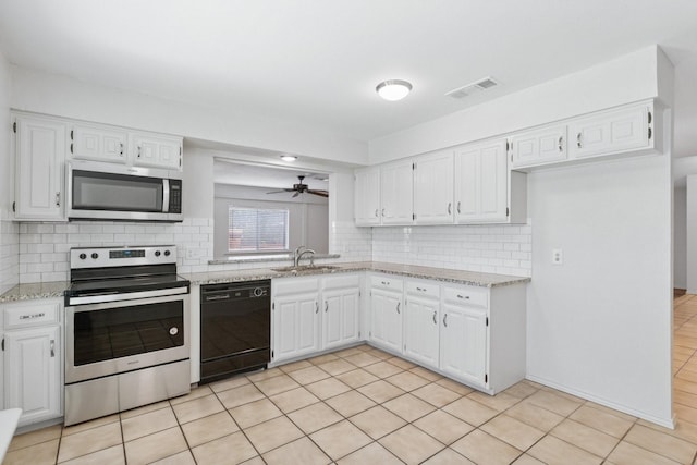1109 Paluxy Ct, Flower Mound, TX 75028 - kitchen featuring appliances with stainless steel finishes, tasteful backsplash, and white cabinets