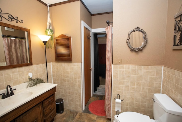 10234 County Road 198, Breckenridge, TX 76424 - bathroom featuring tile walls, vanity, wainscoting, and ornamental molding