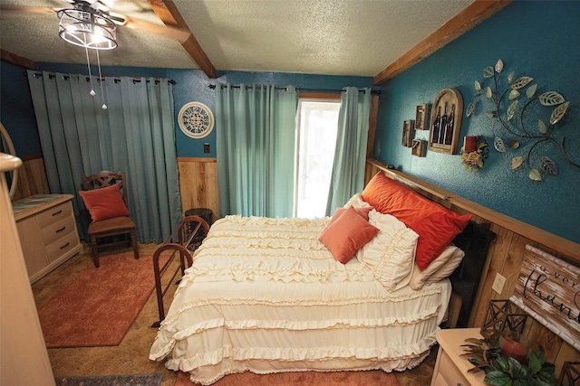 10234 County Road 198, Breckenridge, TX 76424 - carpeted bedroom with a textured ceiling, ceiling fan, and wainscoting