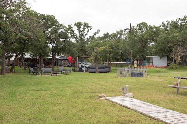 10234 County Road 198, Breckenridge, TX 76424 - view of green lawn with a fire pit