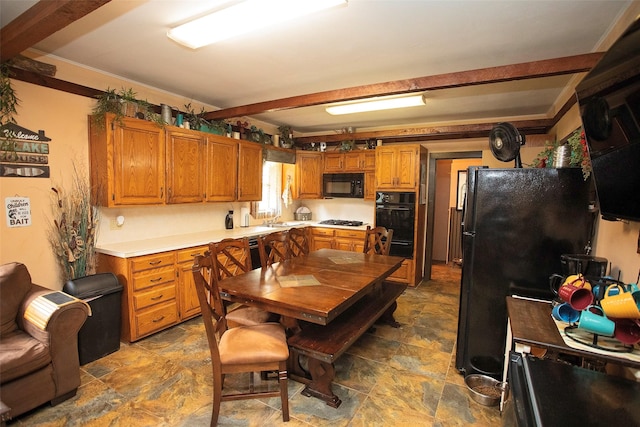 10234 County Road 198, Breckenridge, TX 76424 - kitchen featuring black appliances, stone finish flooring, light countertops, brown cabinetry, and a warming drawer