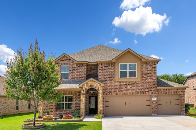 584 Indian Hill Dr, Oak Point, TX 75068 - traditional home featuring brick siding, roof with shingles, concrete driveway, and a front lawn