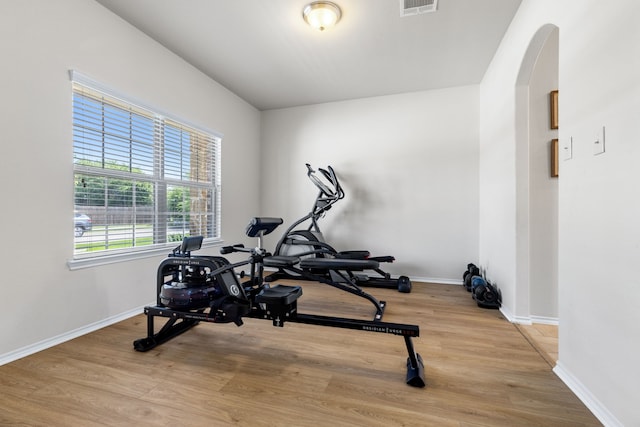 584 Indian Hill Dr, Oak Point, TX 75068 - workout area with wood finished floors and arched walkways
