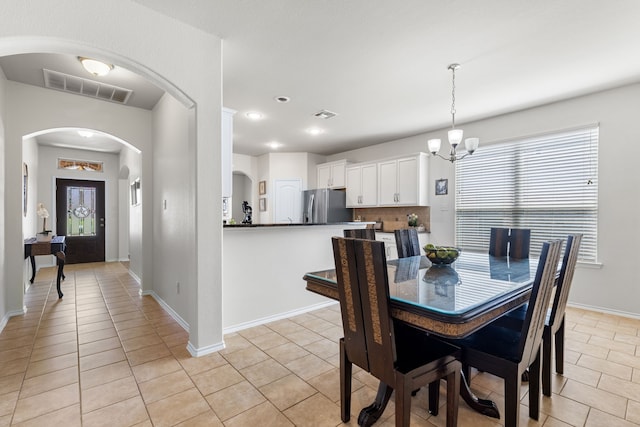 584 Indian Hill Dr, Oak Point, TX 75068 - dining room with light tile patterned floors, a chandelier, arched walkways, and recessed lighting