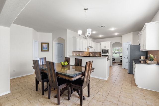 584 Indian Hill Dr, Oak Point, TX 75068 - dining room with a chandelier, arched walkways, light tile patterned floors, and recessed lighting
