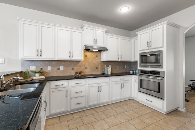 584 Indian Hill Dr, Oak Point, TX 75068 - kitchen featuring appliances with stainless steel finishes, under cabinet range hood, white cabinets, and tasteful backsplash
