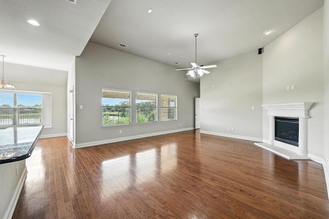 8120 Tyler Dr, Lantana, TX 76226 - unfurnished living room featuring ceiling fan, wood finished floors, a glass covered fireplace, recessed lighting, and a chandelier