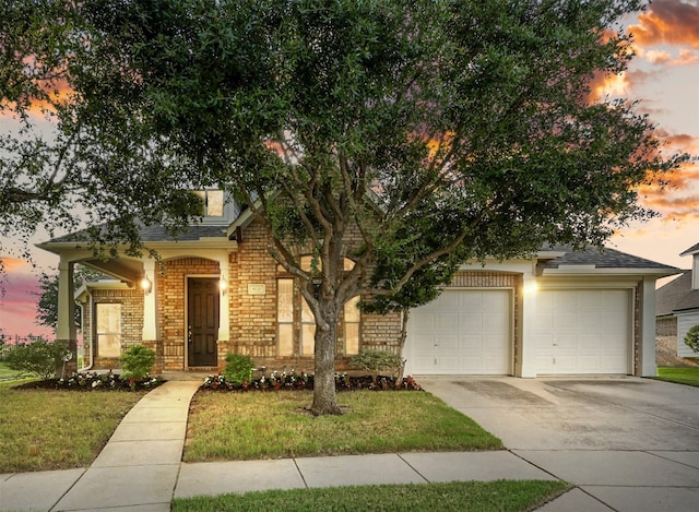 8120 Tyler Dr, Lantana, TX 76226 - view of property hidden behind natural elements featuring concrete driveway, brick siding, an attached garage, and roof with shingles