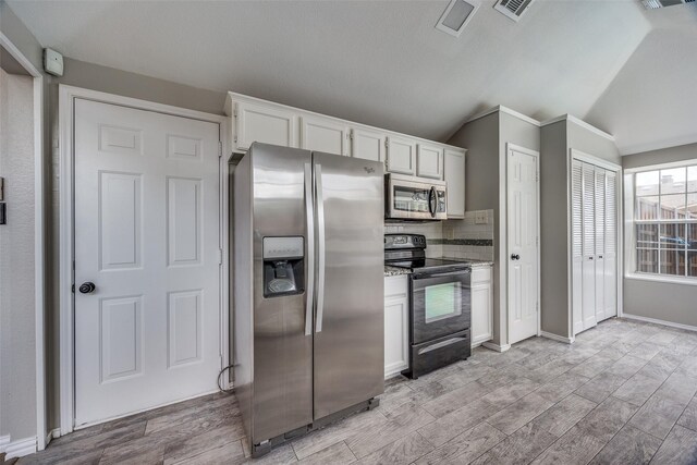 2102 Overview Ln, Garland, TX 75044 - kitchen featuring appliances with stainless steel finishes, light wood-type flooring, vaulted ceiling, white cabinets, and tasteful backsplash