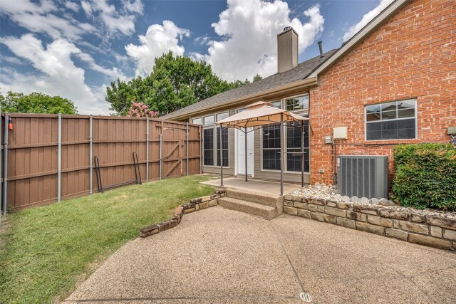 2102 Overview Ln, Garland, TX 75044 - rear view of house featuring a gazebo, a patio, brick siding, a chimney, and a shingled roof