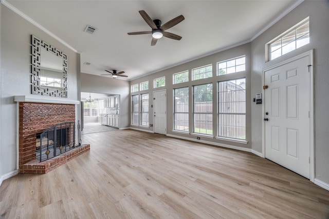 2102 Overview Ln, Garland, TX 75044 - unfurnished living room featuring ornamental molding, a ceiling fan, wood finished floors, a fireplace, and a chandelier