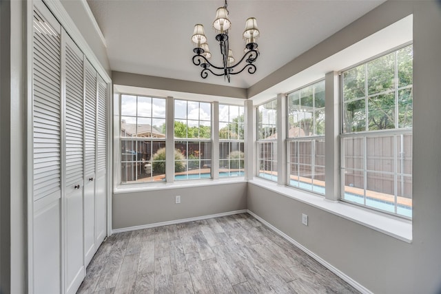 2102 Overview Ln, Garland, TX 75044 - unfurnished sunroom with wood finished floors and a chandelier