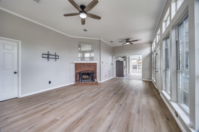 2102 Overview Ln, Garland, TX 75044 - unfurnished living room with ceiling fan, a brick fireplace, wood finished floors, and crown molding