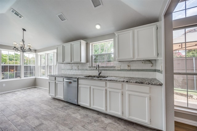 2102 Overview Ln, Garland, TX 75044 - kitchen with stainless steel dishwasher, decorative backsplash, white cabinets, light stone countertops, and lofted ceiling