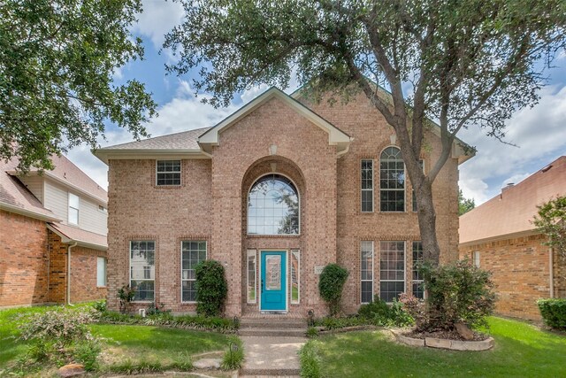 17712 Meadow Grove Ln, Dallas, TX 75287 - traditional home with brick siding and a front yard
