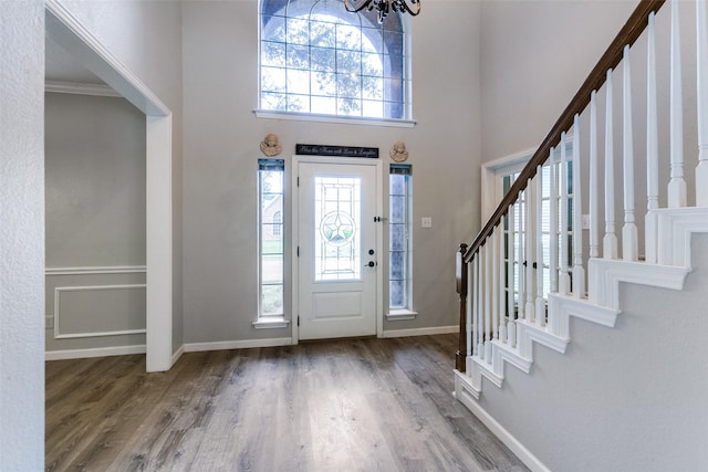 17712 Meadow Grove Ln, Dallas, TX 75287 - foyer entrance featuring a high ceiling, stairs, wood finished floors, and a chandelier