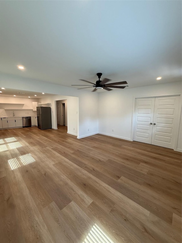 1019 E Waco Ave, Dallas, TX 75216 - unfurnished living room with recessed lighting, light wood-style floors, and a ceiling fan