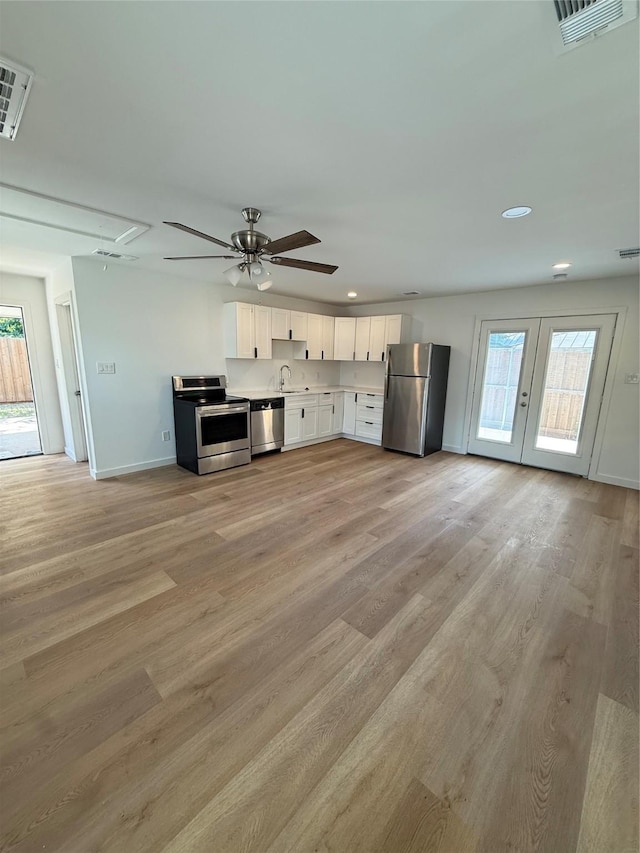 1019 E Waco Ave, Dallas, TX 75216 - unfurnished living room with attic access, plenty of natural light, ceiling fan, light wood-style flooring, and recessed lighting
