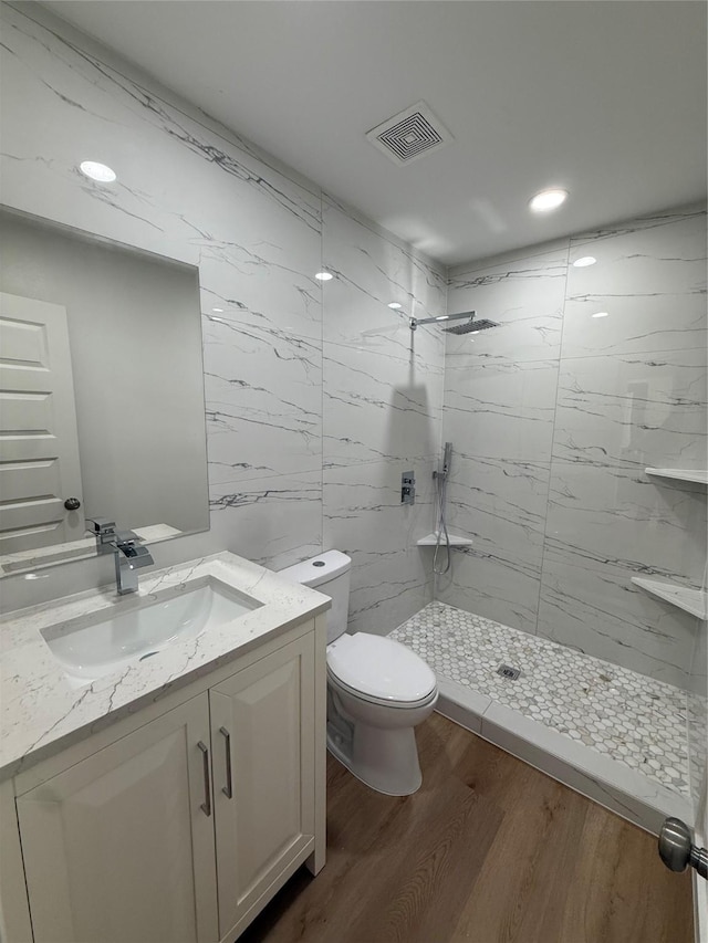 1019 E Waco Ave, Dallas, TX 75216 - full bathroom with a marble finish shower, vanity, wood finished floors, and recessed lighting