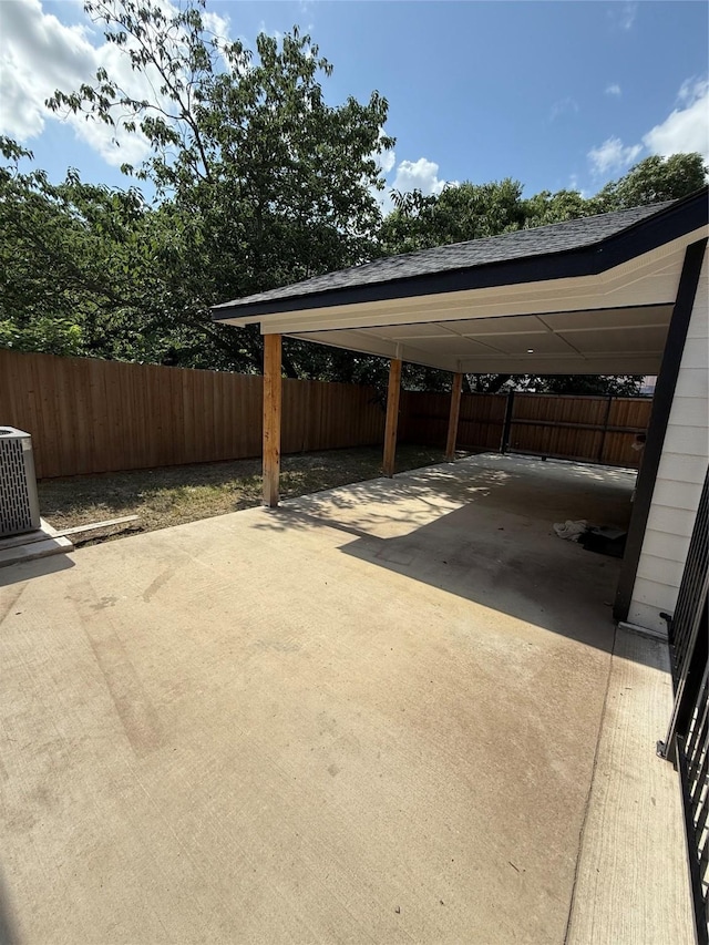 1019 E Waco Ave, Dallas, TX 75216 - view of parking / parking lot featuring concrete driveway and a carport