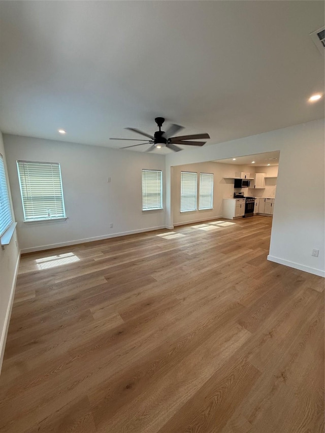 1019 E Waco Ave, Dallas, TX 75216 - unfurnished living room featuring ceiling fan, light wood-style floors, and recessed lighting