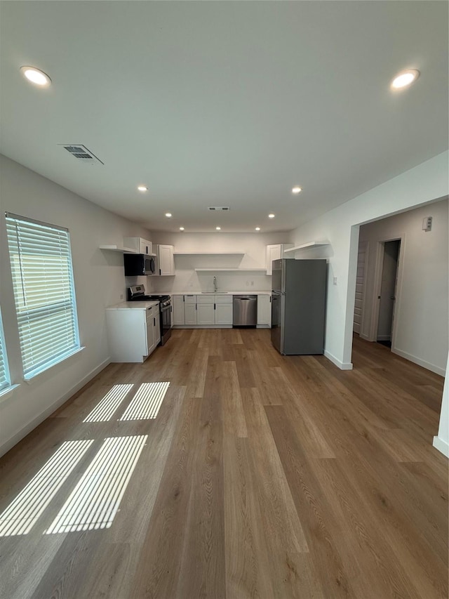 1019 E Waco Ave, Dallas, TX 75216 - unfurnished living room featuring recessed lighting and wood finished floors