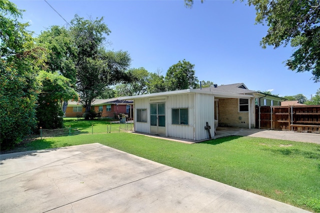 5428 Sabelle Ln, Haltom City, TX 76117 - rear view of property featuring a patio area, board and batten siding, brick siding, and a carport