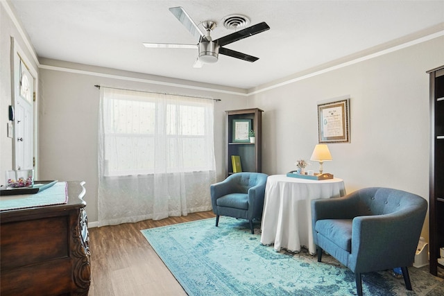 5428 Sabelle Ln, Haltom City, TX 76117 - sitting room with wood finished floors, ceiling fan, and crown molding