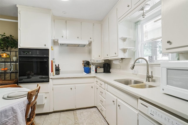 5428 Sabelle Ln, Haltom City, TX 76117 - kitchen with white appliances, under cabinet range hood, decorative backsplash, light countertops, and white cabinetry