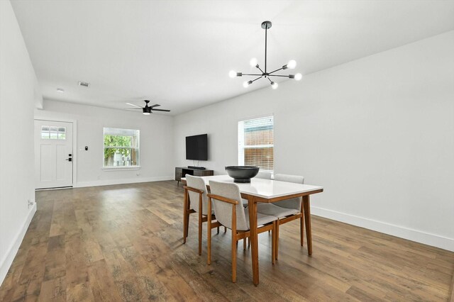 1415 W St, Mckinney, TX 75069 - dining space with a chandelier, dark wood-type flooring, and ceiling fan