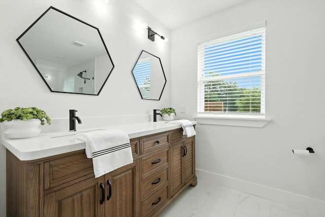 1415 W St, Mckinney, TX 75069 - bathroom featuring double vanity, marble finish floors, and a shower