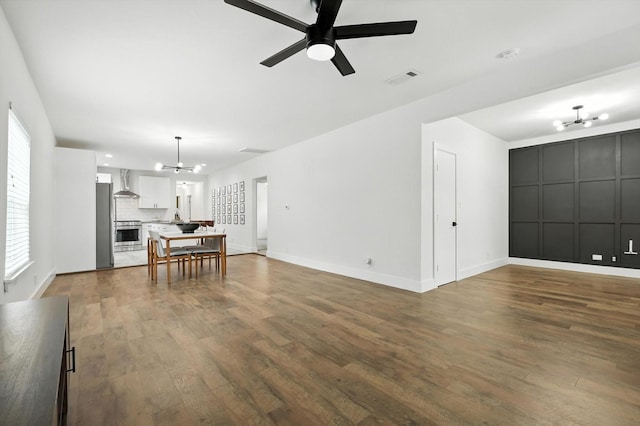 1415 W St, Mckinney, TX 75069 - living room featuring dark wood-type flooring, ceiling fan, and a chandelier