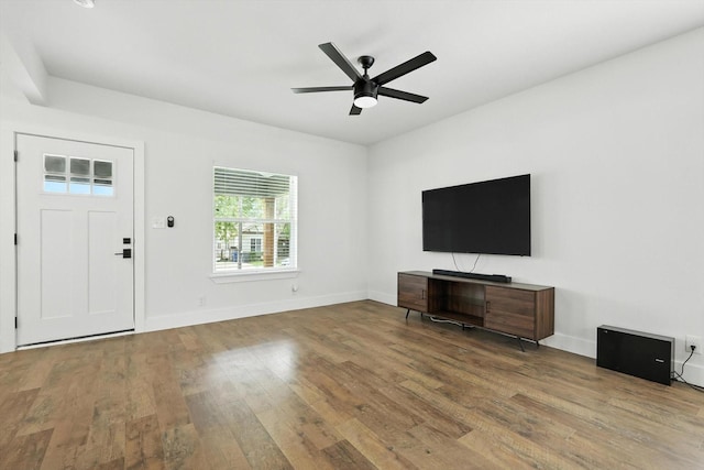 1415 W St, Mckinney, TX 75069 - unfurnished living room with wood finished floors and ceiling fan