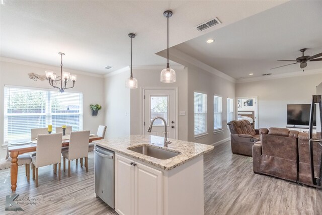 7309 Wildflower Way, Abilene, TX 79602 - kitchen with dishwasher, light wood-style floors, light stone counters, open floor plan, and crown molding