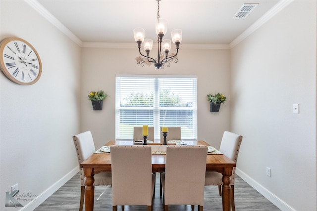 7309 Wildflower Way, Abilene, TX 79602 - dining space with wood finished floors, a chandelier, and ornamental molding