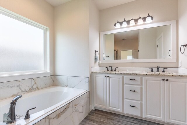 7309 Wildflower Way, Abilene, TX 79602 - bathroom featuring double vanity, a bath, and wood finished floors
