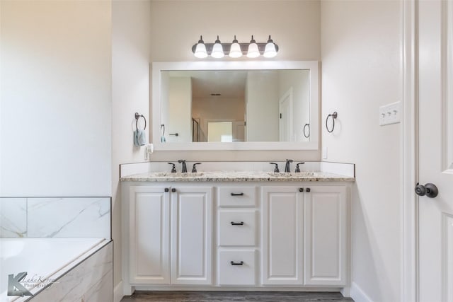 7309 Wildflower Way, Abilene, TX 79602 - bathroom with double vanity and a tub with marble appearance