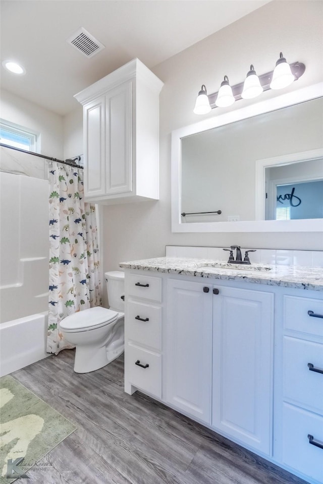 7309 Wildflower Way, Abilene, TX 79602 - full bathroom featuring vanity, wood finished floors, and shower / bath combination with curtain