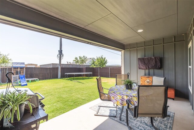 7309 Wildflower Way, Abilene, TX 79602 - fenced backyard with a trampoline, a patio area, outdoor dining space, and a playground