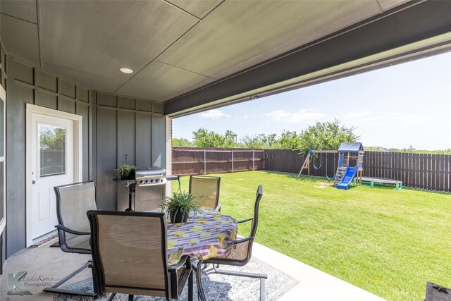 7309 Wildflower Way, Abilene, TX 79602 - fenced backyard featuring a playground, a patio, outdoor dining space, and grilling area