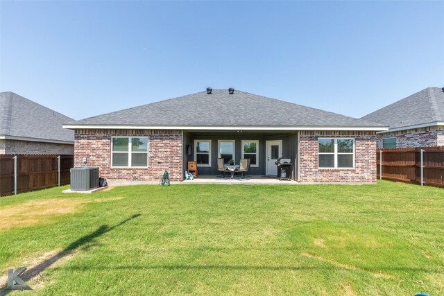 7309 Wildflower Way, Abilene, TX 79602 - rear view of property with brick siding, a fenced backyard, roof with shingles, and a patio