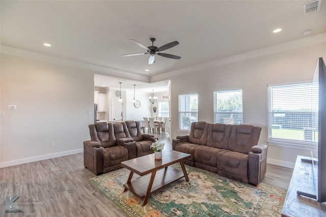 7309 Wildflower Way, Abilene, TX 79602 - living room with a ceiling fan, light wood finished floors, crown molding, recessed lighting, and a chandelier