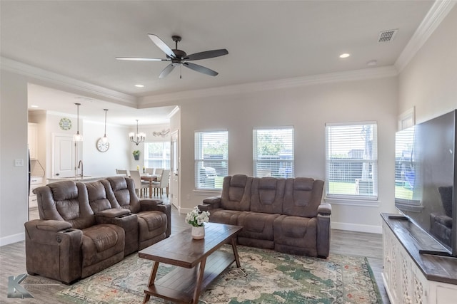 7309 Wildflower Way, Abilene, TX 79602 - living area featuring wood finished floors, ornamental molding, ceiling fan, a chandelier, and recessed lighting