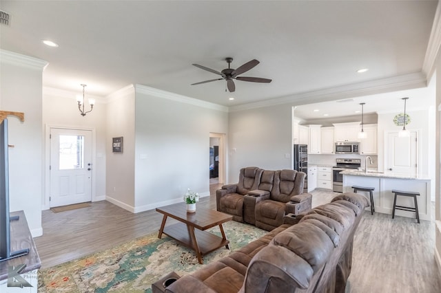 7309 Wildflower Way, Abilene, TX 79602 - living area with light wood-style floors, ornamental molding, a ceiling fan, recessed lighting, and a chandelier