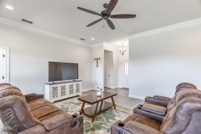 7309 Wildflower Way, Abilene, TX 79602 - living room with ornamental molding, ceiling fan, wood finished floors, recessed lighting, and a chandelier