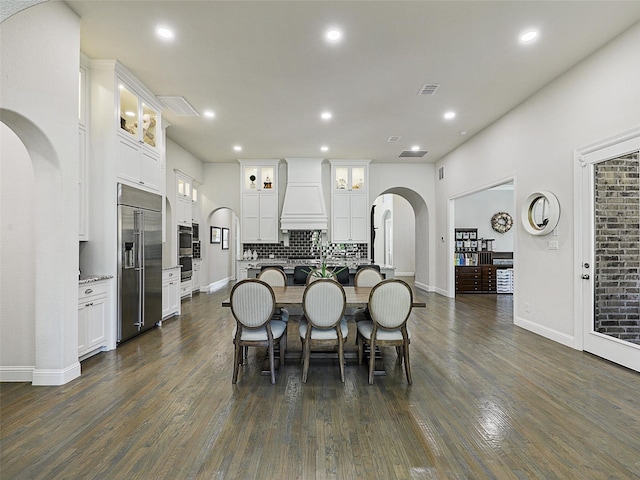 13002 Terlingua Creek Dr, Frisco, TX 75033 - dining room featuring arched walkways, dark wood-type flooring, and recessed lighting