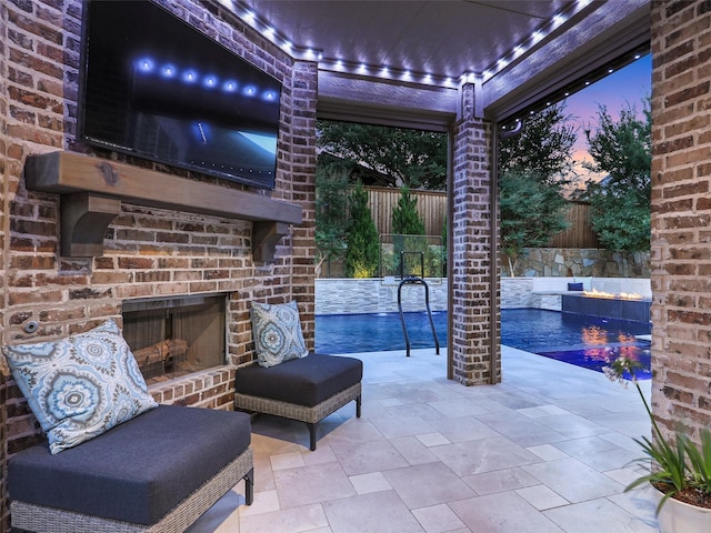 13002 Terlingua Creek Dr, Frisco, TX 75033 - patio terrace at dusk featuring an outdoor brick fireplace, a fenced backyard, and a patio area